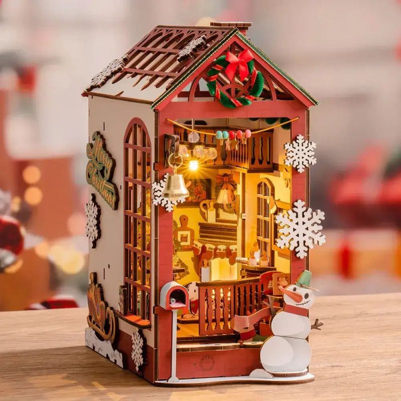 Snowy indoor miniature village book shelf vignette with fireplace and holiday decor