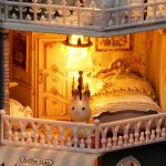 starry-miniature-house-craft-kit-with-led-fairy-lights Starry miniature house craft kit with warm white LED fairy lights glowing through all windows at dusk