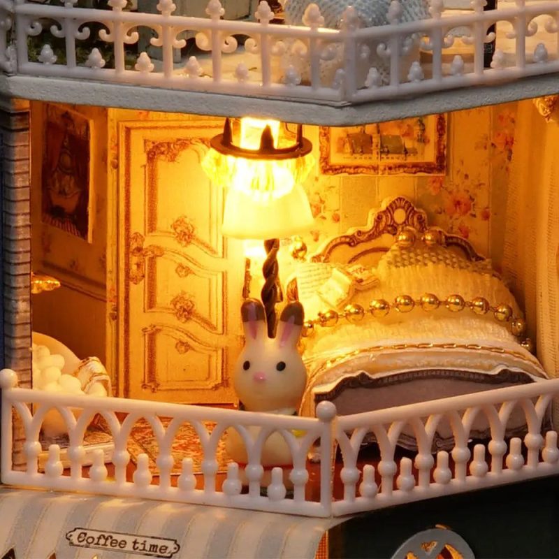 starry-miniature-house-craft-kit-with-led-fairy-lights Starry miniature house craft kit with warm white LED fairy lights glowing through all windows at dusk