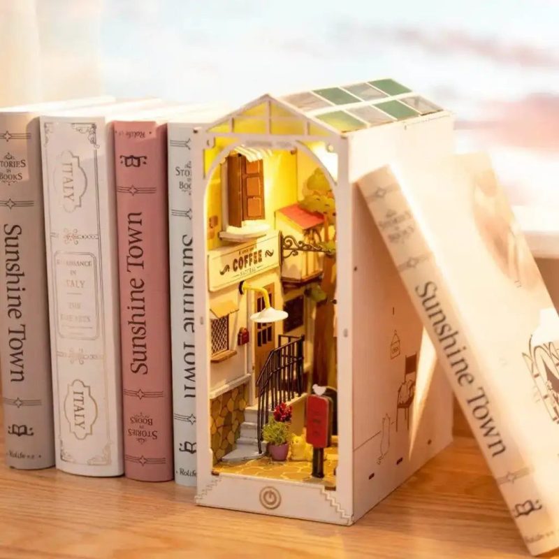 sunlit-miniature-book-nook-diorama-for-bookshelf Sunlit miniature book nook diorama sitting upright between books on a wooden bookshelf