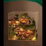 tabletop-fairy-cottage-diy-kit-with-warm-led-lighting Tabletop fairy cottage DIY kit showing warm LED glow through tiny windows