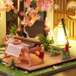 tiny-guqin-zither-model-for-dollhouse-decoration Tiny guqin zither model surrounded by paper blossoms for dollhouse decoration