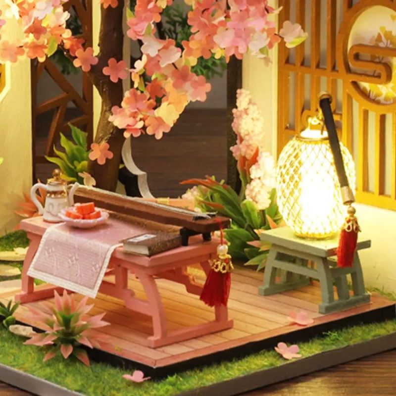 tiny-guqin-zither-model-for-dollhouse-decoration Tiny guqin zither model surrounded by paper blossoms for dollhouse decoration