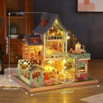 tiny-jungle-resort-dollhouse-kit-with-detailed-decor-pieces Tiny jungle resort miniature house kit showing detailed decor and music mechanism