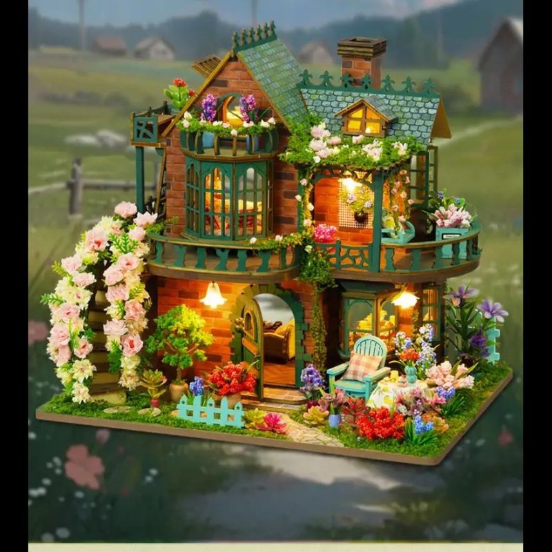Tiny wooden fairy house kit assembled and placed on a windowsill