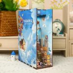travel-inspired-mini-bookshelf-scene-made-from-wood Travel-inspired mini bookshelf scene made from sustainably sourced wood with hand-painted details