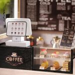 vintage-style-miniature-cafe-diorama-for-miniature-collectors Vintage-style miniature café diorama with warm lighting and wood tones